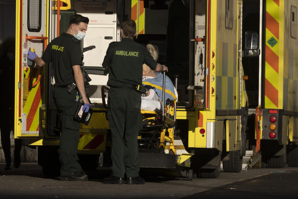 LONDON, ENGLAND - JANUARY 07: Ambulance crew move patients at the Royal London Hospital on January 07, 2022 in London, England. By the New Year, nearly one in 10 NHS staff were off work with 50,000 at home either sick or self-isolating. (Photo by Dan Kitwood/Getty Images)