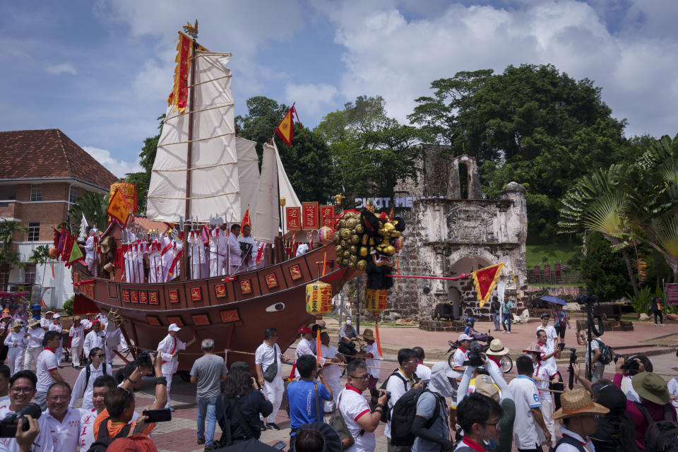 Ethnic Chinese devotees pull a special Wangkang ship through a nine-kilometer procession route in the historical city of Malacca with 22 stops where priests performed cleansing rituals to command evil spirits and other negative influences to board the boat during Wangkang or "royal ship" festival in Malacca, Malaysia, Thursday, Jan. 11, 2024. The Wangkang festival was brought to Malacca by Hokkien traders from China and first took place in 1854. Processions have been held in 1919, 1933, 2001, 2012 and 2021. (AP Photo/Vincent Thian)