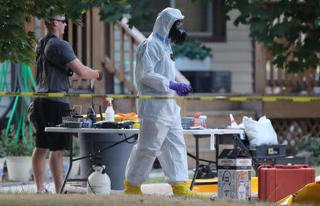 FBI and law enforcement officers in hazmat suites prepare to enter a house, which FBI says was investigating "potentially hazardous chemicals" in Logan, Utah, U.S., October 3, 2018. REUTERS/George Frey