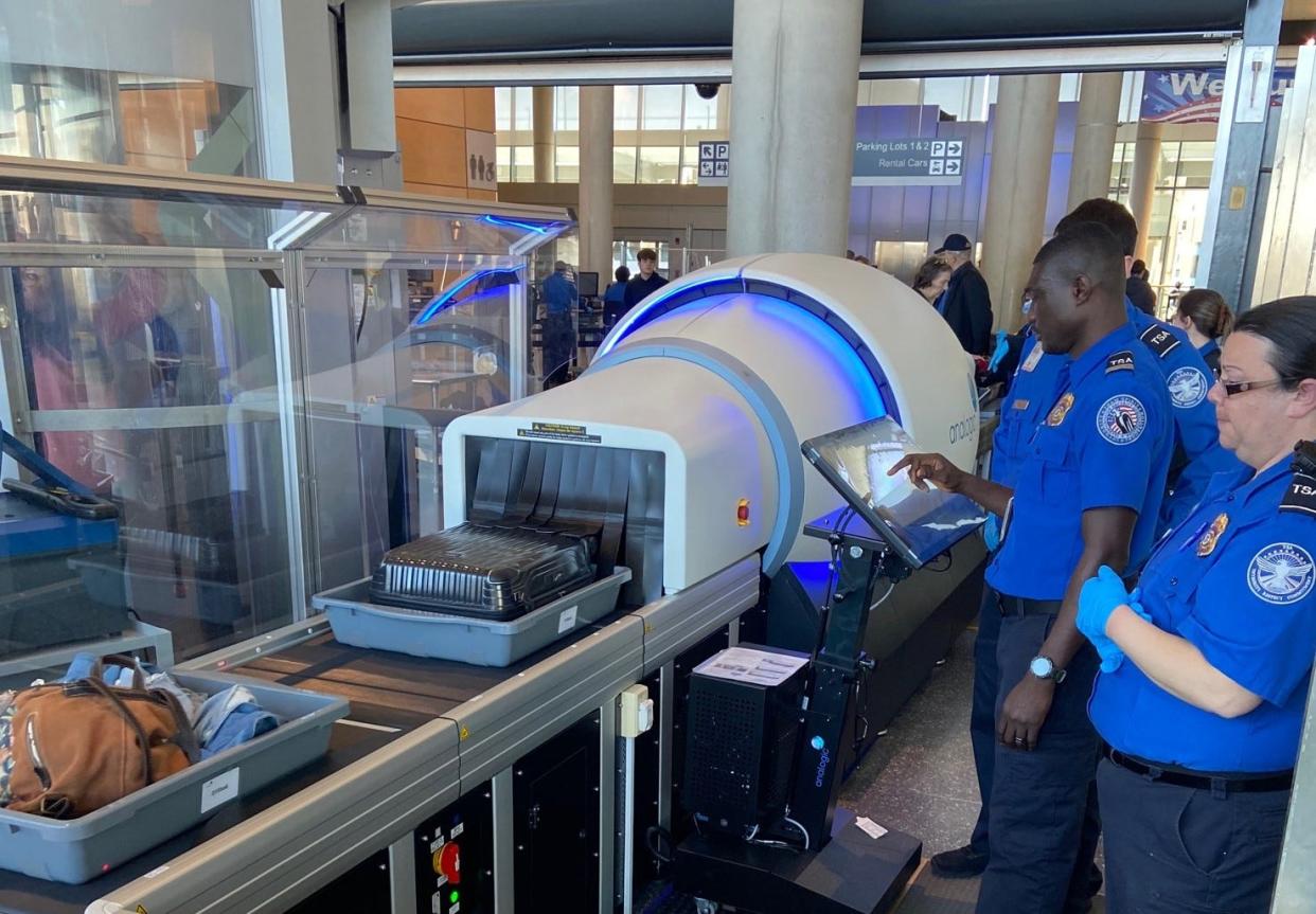 Transportation security officers at the Bradley International Airport in Connecticut work with a mid-sized CT. Asheville is getting three, according to the TSA.
