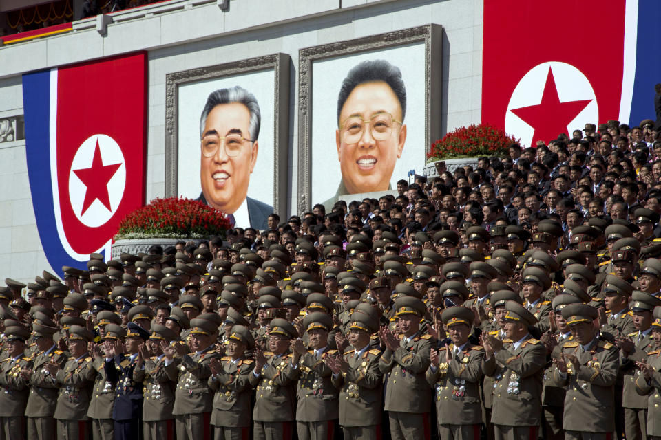 North Korean military officers applaud near portraits of late North Korean leaders Kim Il Sung and Kim Jong Il during a parade for the 70th anniversary of North Korea's founding day in Pyongyang, North Korea, Sunday, Sept. 9, 2018. North Korea staged a major military parade, huge rallies and will revive its iconic mass games on Sunday to mark its 70th anniversary as a nation. (AP Photo/Ng Han Guan)