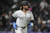 Colorado Rockies' Brendan Rodgers heads toward first after hitting a grand slam off San Diego Padres starting pitcher Michael King during the fourth inning of a baseball game Tuesday, April 23, 2024, in Denver. (AP Photo/David Zalubowski)