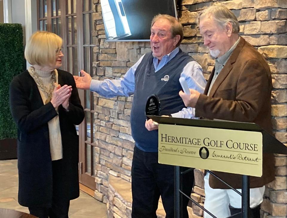 Past Special Olympics president Tony Crowder, center, was presented with the inaugural volunteer services award by Hermitage Golf Course owners Mike and Barbara Eller.