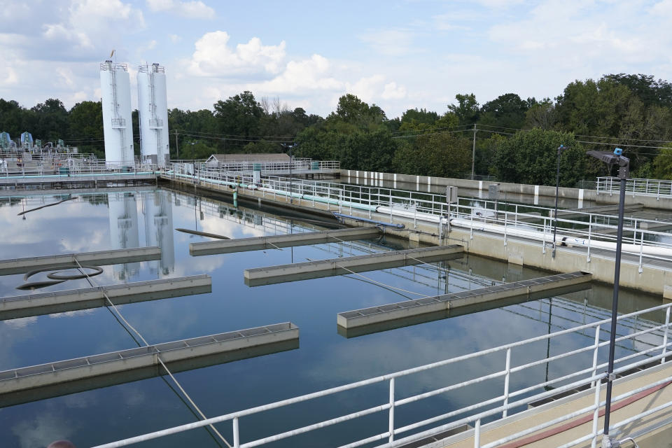 FILE - Clouds are reflected off the City of Jackson's O.B. Curtis Water Treatment Facility's sedimentation basins in Ridgeland, Miss., Sept. 2, 2022. Officials in Jackson said the city's water system, which partially collapsed in late August, was experiencing “fluctuating” pressure on Saturday, Dec. 24, amid frigid temperatures. (AP Photo/Rogelio V. Solis, File)