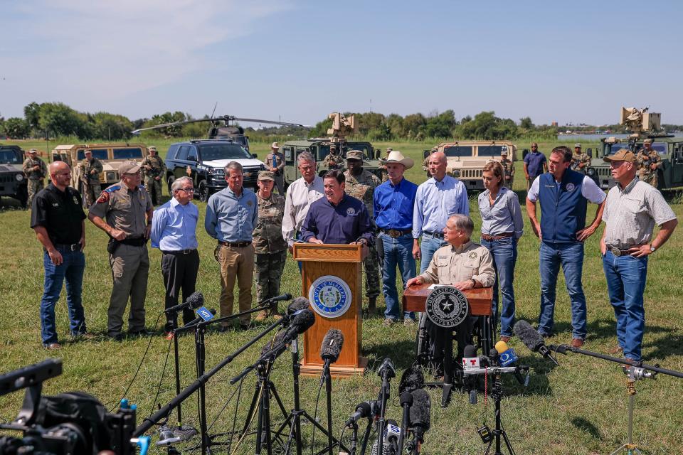 Arizona Governor Doug Ducey, left, joins other Republican governors like Texas Governor Greg Abbot, right, Texas National Guard leaders, and law enforcement officers at a press conference on the Texas-Mexico border in Mission, Texas on Oct. 6, 2021 to speak on the Biden Administration's lack of action on the continuing crisis at the border.