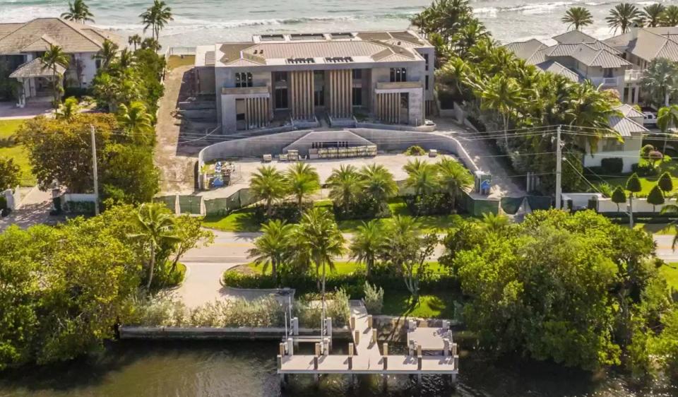 A bird's-eye photo from early 2022 shows the ocean-to-lake site near Palm Beach at 1460 S. Ocean Blvd. in Manalapan, where a mansion is under construction with 25,576 square feet of living space, inside and out. The photo was released when the property first entered the multiple listing service.