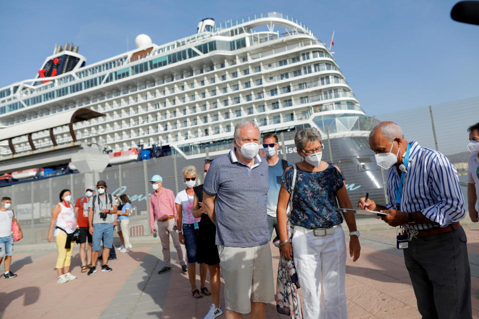 German tourists disembark for sightseeing from the cruise ship 'Mein Schiff 2' of the company TUI Cruises after it was docked at dawn in Malaga port, becoming the first cruise ship carrying tourists to arrive on Spain's mainland since June 2020, amid the coronavirus disease (COVID-19) pandemic, in Malaga, southern Spain, June 15, 2021. REUTERS/Jon Nazca