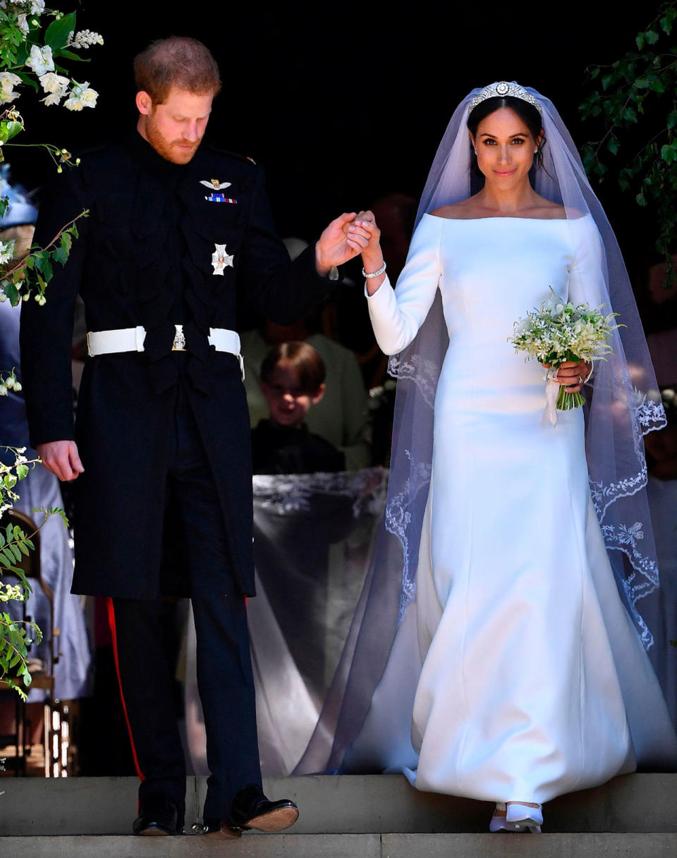 <p>Meghan Markle wears an off-the-shoulder white gown by Givenchy for her royal wedding to Prince Harry. (Photo: Getty images) </p>