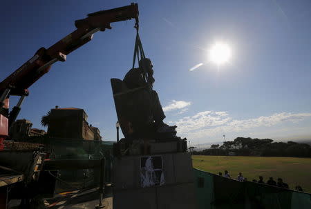 A crane stands ready to remove the statue of Cecil John Rhodes from the University of Cape Town (UCT), April 9, 2015. UCT's Council voted on Wednesday to remove of the statue of the former Cape Colony governor, after protests by students. REUTERS/Mike Hutchings