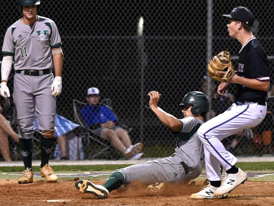 Venice's Marek Houston scores in the top of the seventh inning after a wild pitch by Sameon Klanot, on right, during the game. Riverview Rams lost 4-1 as visiting Venice triumphed on Friday night, March 25, 2022, at the Rams field, played at the Suncoast Technical College, in Sarasota.