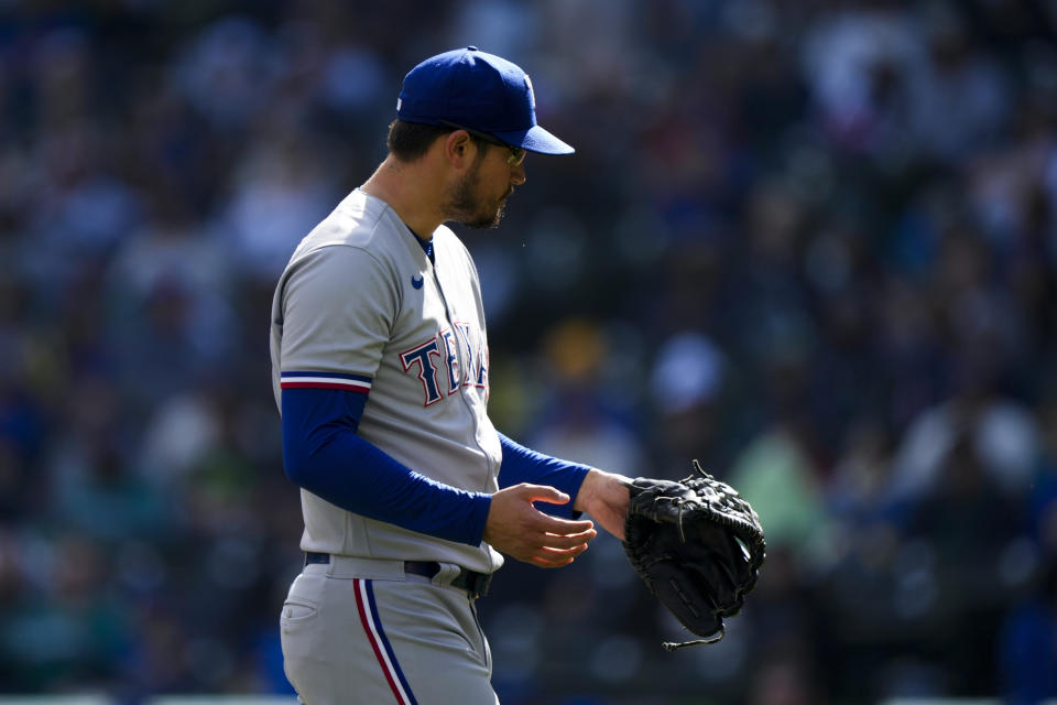 Texas Rangers starting pitcher Dane Dunning walks off the field after pitching against the Seattle Mariners during the first inning of a baseball game, Sunday, Oct. 1, 2023, in Seattle. (AP Photo/Lindsey Wasson)