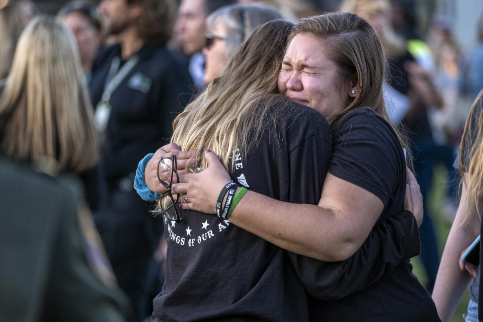 Ruthie Nadler cries as she hugs Madeline Harvey during the dedication of the Borderline Healing Garden at Conejo Creek Park in Thousand Oaks, Calif., Thursday, Nov. 7, 2019. Nadler and Harvey were at the Borderline club when a mass shooting occurred one year ago. (Hans Gutknecht/The Orange County Register via AP)