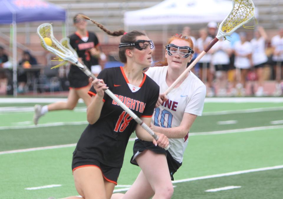 Brighton's Cece Mainhardt (18) handles the ball while defended by Forest Hills Northern-Eastern's Vivian Reinink (10) during the state Division 1 girls lacrosse championship game Saturday, June 10, 2023 in Rockford.