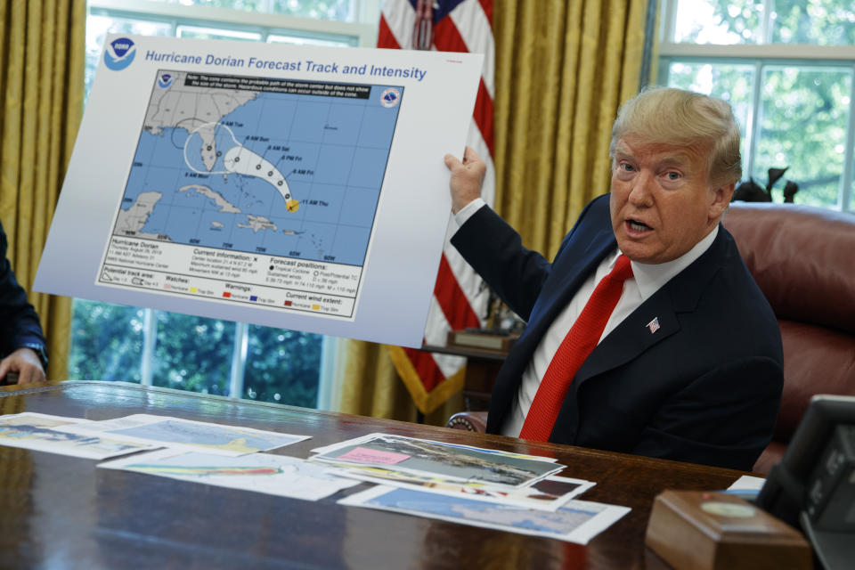 President Trump talks with reporters after receiving a briefing on Hurricane Dorian in the Oval Office of the White House in Washington, D.C., on Wednesday. (AP Photo/Evan Vucci)    