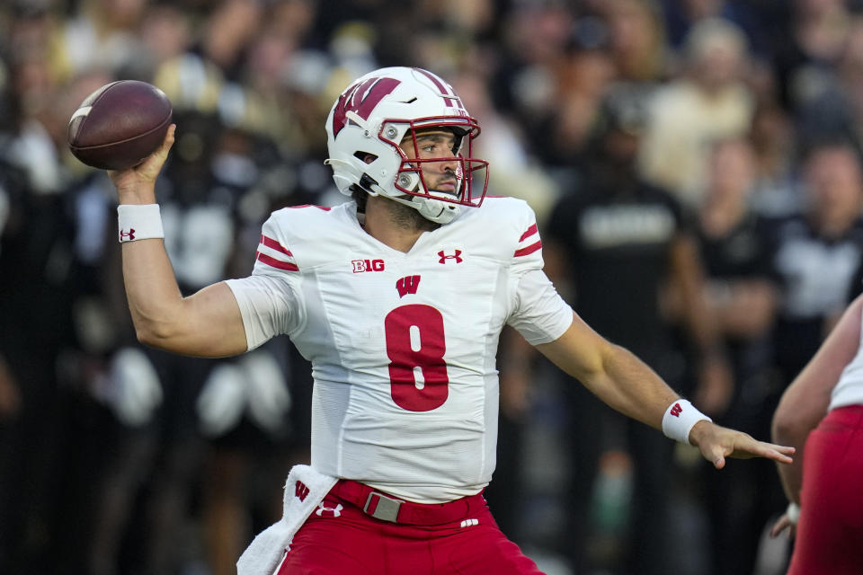 Wisconsin quarterback Tanner Mordecai (8) throws against Purdue during the first half of an NCAA college football game in West Lafayette, Ind., Friday, Sept. 22, 2023. (AP Photo/Michael Conroy)
