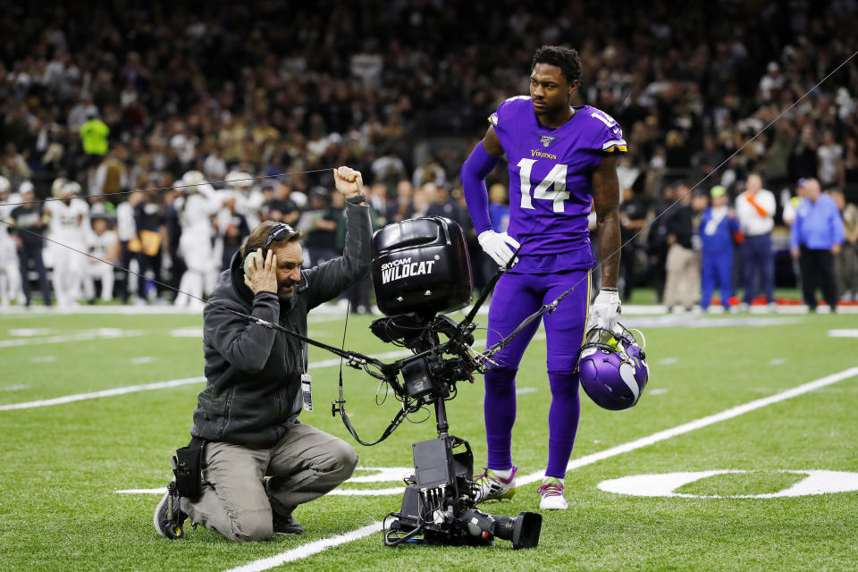 Vikings' receiver Stefon Diggs looks on as a technician tends to the SkyCam. (Kevin C. Cox/Getty Images)