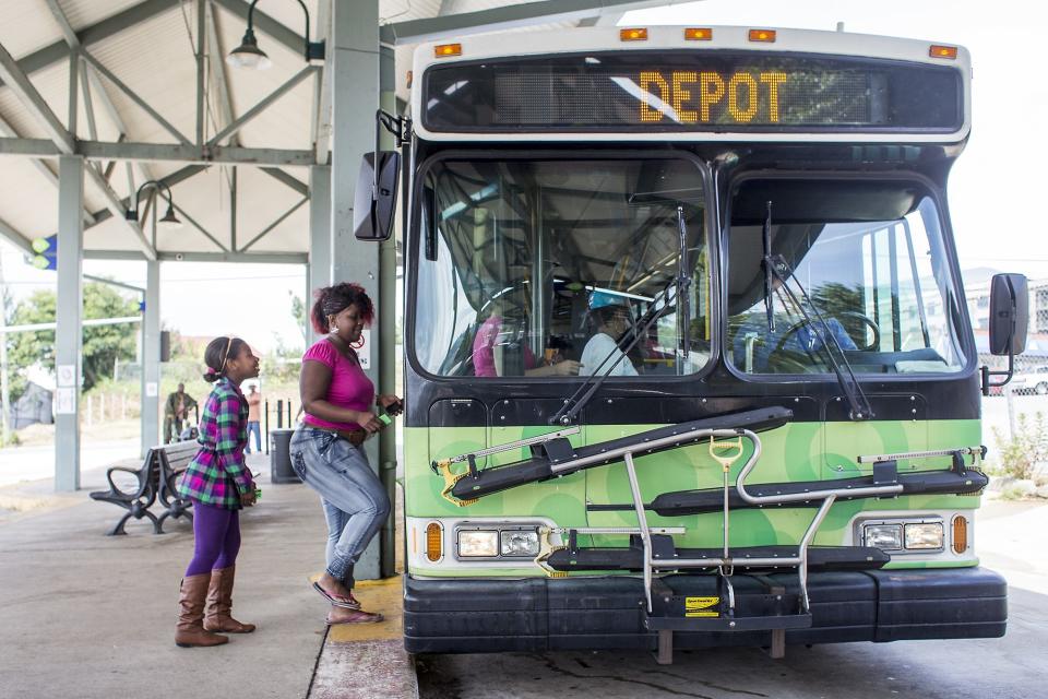 Omani Davis, 10, left, and mom Crystal Davis, center, board the S4S bus at the ART Station, or Asheville Transit Center, on Coxe Avenue in Downtown Asheville, Monday last year. Asheville Transit will offer free bus rides on Wednesday
