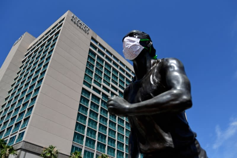 A general view of astatue with protective masks on outside of the Hyatt Regency the host hotel for UFC 249 at VyStar Veterans Memorial Arena