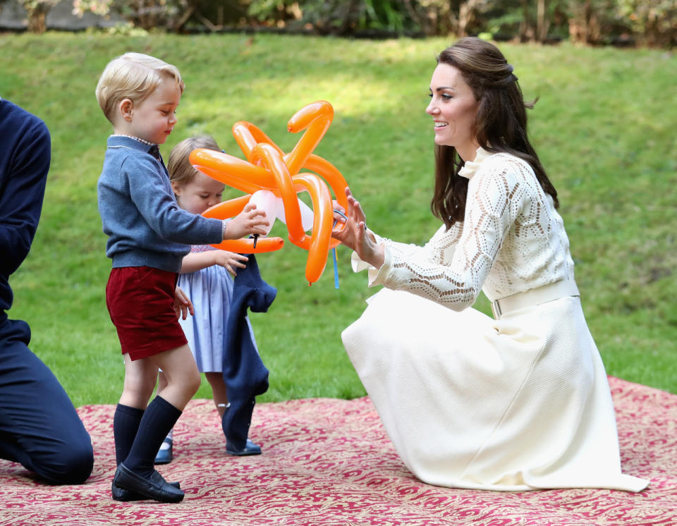 The Duchess of Cambridge and her children play with balloon animals. (Photo: Getty Images)