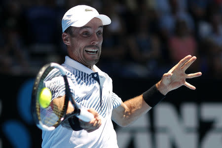 Tennis - Australian Open - Quarter-final - Melbourne Park, Melbourne, Australia, January 22, 2019. Spain's Roberto Bautista Agut in action with Greece's Stefanos Tsitsipas. REUTERS/Adnan Abidi