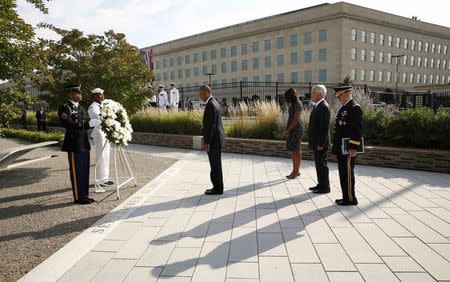 U.S. President Barack Obama lays a wreath at the National 9/11 Pentagon Memorial during a ceremony marking the 13th anniversary of the 9/11 attacks at the Pentagon in Washington September 11, 2014. REUTERS/Kevin Lamarque