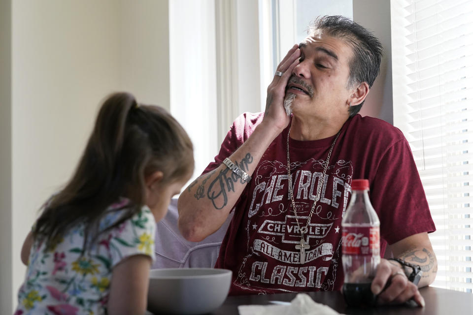 Leroy Pascubillo wipes away tears as he looks at his daughter, who was born addicted to heroin and placed with a foster family at birth, and talks about his journey regaining custody, May 10, 2021, in Seattle. Pascubillo, who had used drugs for the better part of four decades, was in a court-ordered in-patient drug rehab program when the pandemic first hit. (AP Photo/Elaine Thompson)