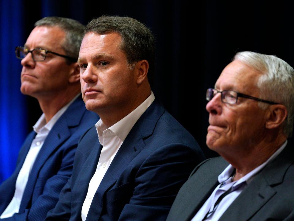 Greg Penner, Doug McMillon, Rob Walton sit together during Walmart event