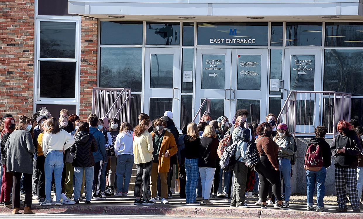 About 120 students from Hickman High School stand outside the east entrance of the school earlier this month during a planned walkout to protest the Columbia school board’s decision to rescind the mask mandate for Columbia Public Schools.