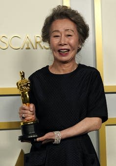 Youn Yuh-jung poses in the press room at the Oscars.