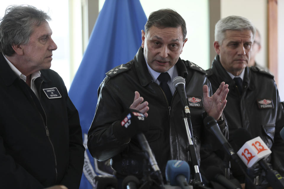 Chile's Air Force Commander Arturo Merino, center, speaks during a news conference at the Chilean Air Force base in Punta Arenas, Chile, Thursday, Dec. 12, 2019. Chile's Defense Minister Alberto Espina said human remains have been found from a military aircraft that disappeared on a flight to Antarctica.The plane was carrying 38 passengers when it took off from southernmost Chile on Monday.Th man on the left is the Chile's Defense Minister Alberto Espina and the right is the Gen. Cristian Pizarro, the commander of rescue mission. (AP Photo/Fernando Llano)