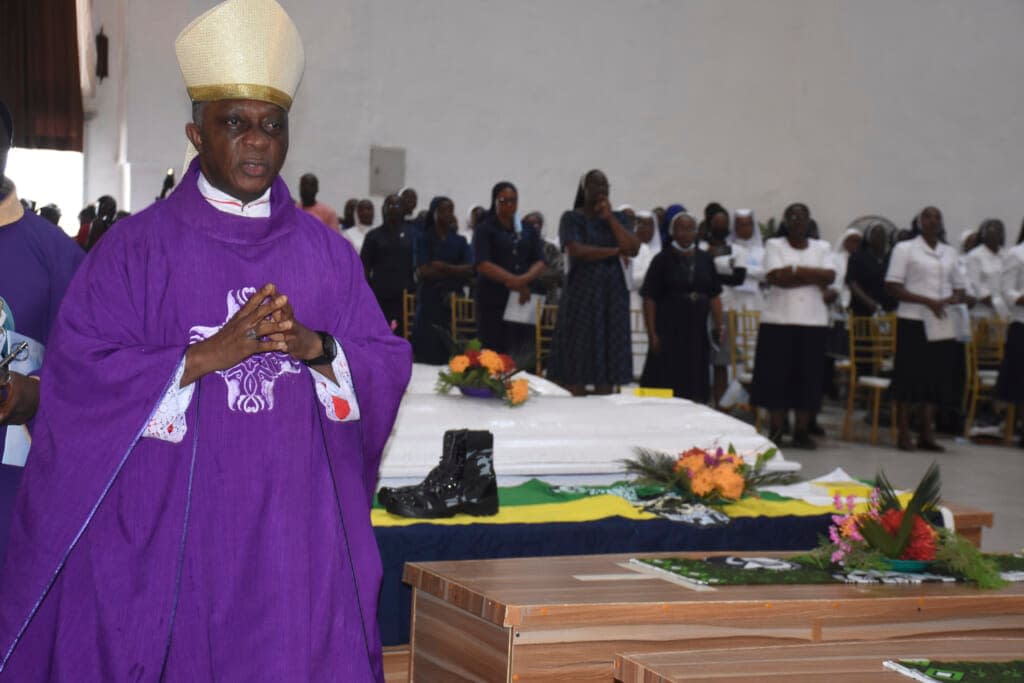 Mourners pay their respects to the victims killed at the St. Francis Catholic Church on June 5, during a funeral service in Owo, southwestern Nigeria, Friday, June 17. Nigeria held a state funeral for nearly two dozen of the worshippers killed by gunmen at the church service. (AP Photo/Rahaman A Yusuf)