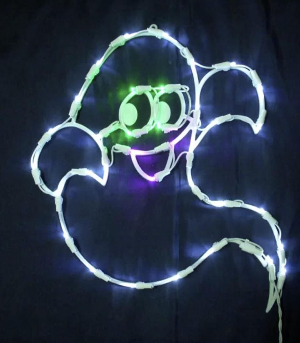 The ghost character shaped  has green eyes, a purple mouth and white body