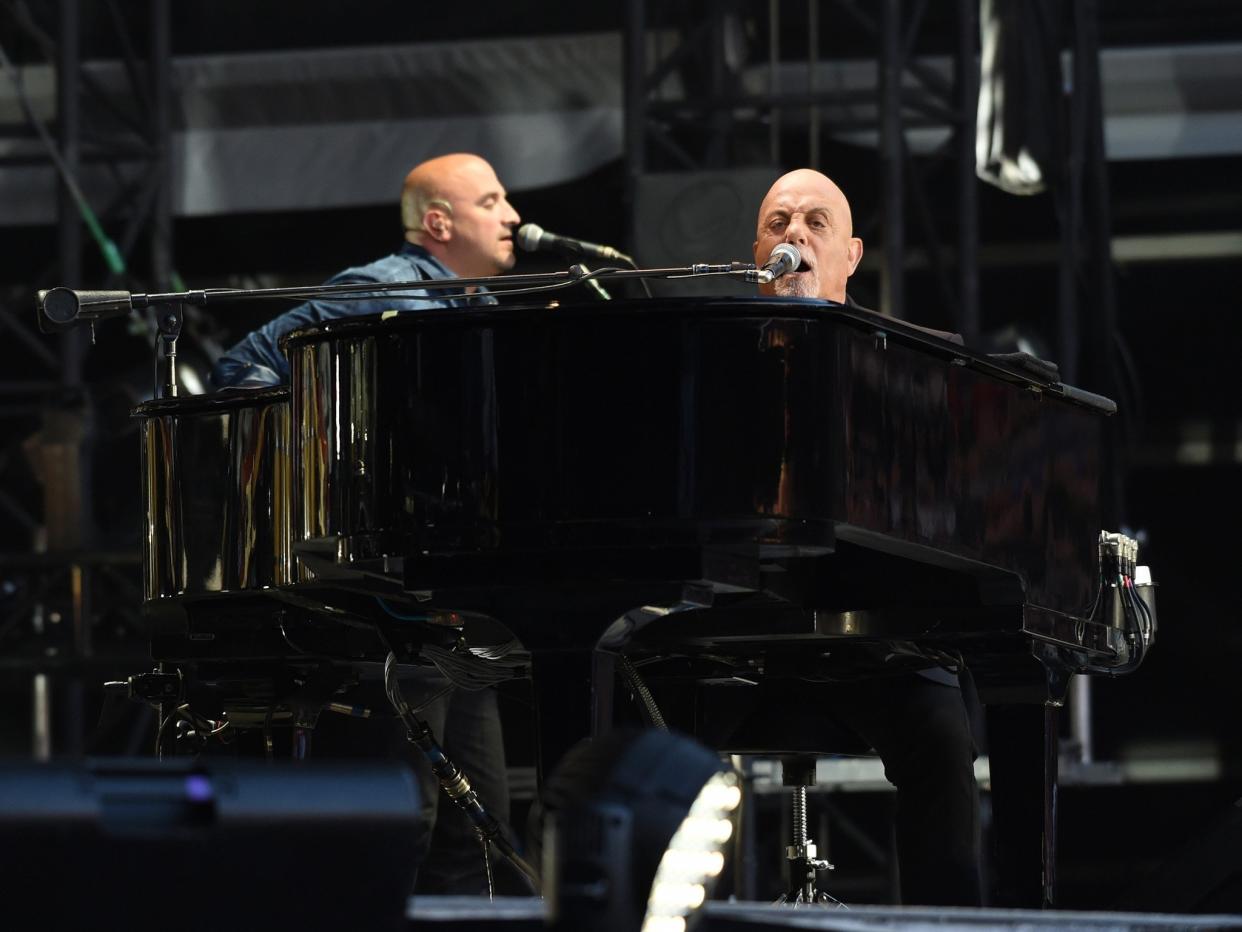 Billy Joel performing to a sell out crowd at Old Trafford Football Ground in Manchester: FARRELL / BACKGRID