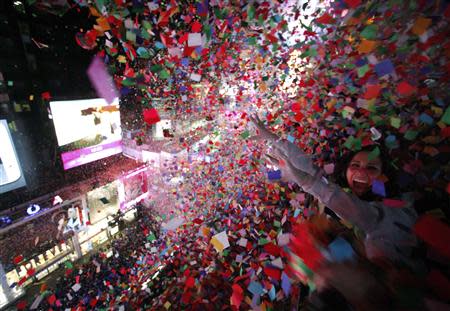 Confetti is dropped on revelers at midnight during New Year's Eve celebrations in Times Square in New York January 1, 2014. REUTERS/Gary Hershorn