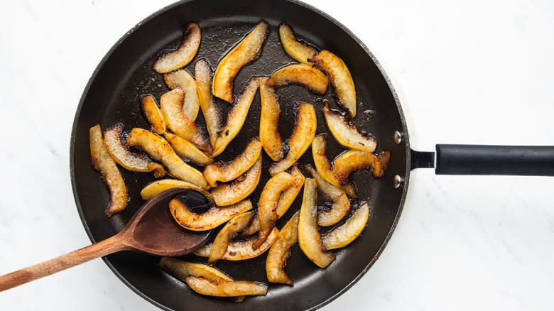 sliced pears cooking in pan