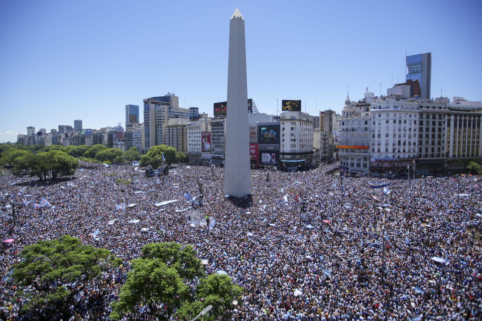 Argentine soccer fans descend on the Obelisk monument for a homecoming parade for the Argentine soccer team that won the World Cup tournament in Buenos Aires, Argentina, Tuesday, Dec. 20, 2022. (AP Photo/Matilde Campodonico)