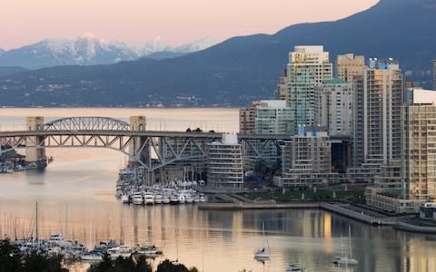 view of Vancouver Canada water side and snowy mountains - Credit: Albert Normandin/Destinatinon BC