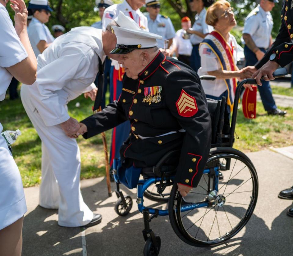 Parade grand marshal, U.S. Marines Sgt. Michael Sulsona, greets a Navy veteran before the start of the 104th annual Memorial Day parade on Monday in the Staten Island borough of New York City. Sulsona is a disabled combat Vietnam veteran who was wounded in action on January 15, 1971. He received the Purple Heart and Bronze Star.