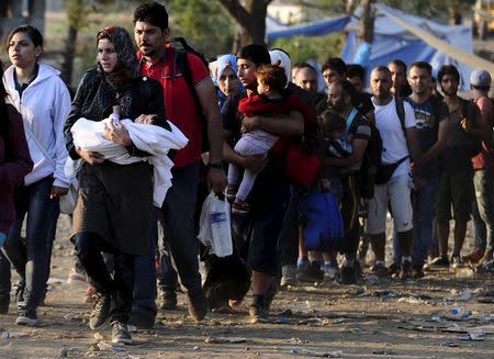 Migrants enter Macedonia near Gevgelija after crossing the border with Greece, September 1, 2015. Migrants are trekking from the southern Macedonian border near Gevgelija to the northern border with Serbia on their way to Western Europe. REUTERS/Ognen Teofilovski