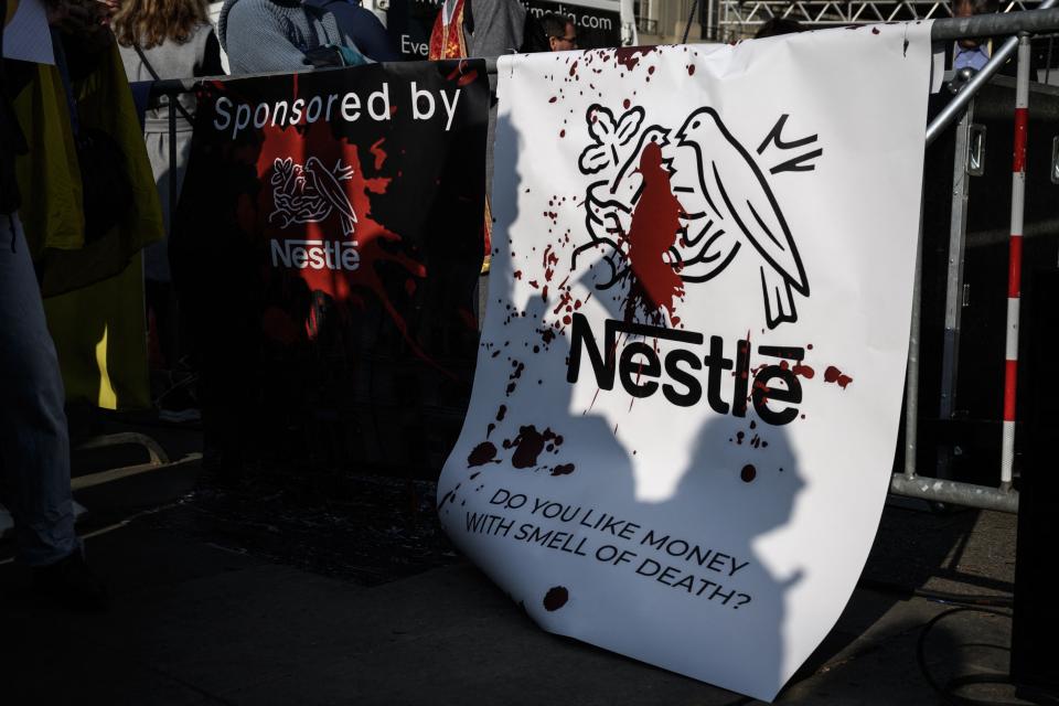Banners against Swiss food giant Nestle are seen during a protest outside Swiss parliament in Bern (AFP/Getty)