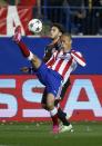 Atletico Madrid's Joao Miranda (R) is challenged by Bayer Leverkusen's Josip Drmic during their Champions League Round of 16 second leg soccer match at the Vicente Calderon stadium in Madrid, March 17, 2015. REUTERS/Paul Hanna (SPAIN - Tags: SPORT SOCCER)