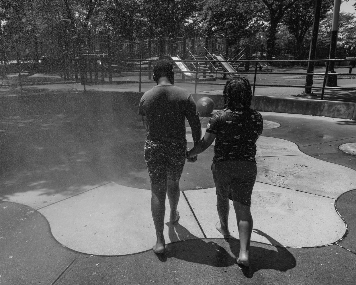 Ronisha's sons playing in the sprinklers at park near their home. (Stephanie Mei-Ling for NBC News and ProPublica)