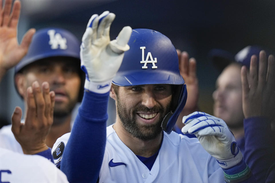 Los Angeles Dodgers' Chris Taylor is congratulated after his two-run home run in the second inning against the Atlanta Braves in Game 5 of baseball's National League Championship Series Thursday, Oct. 21, 2021, in Los Angeles. Pujols scored on the hit. (AP Photo/Jae C. Hong)