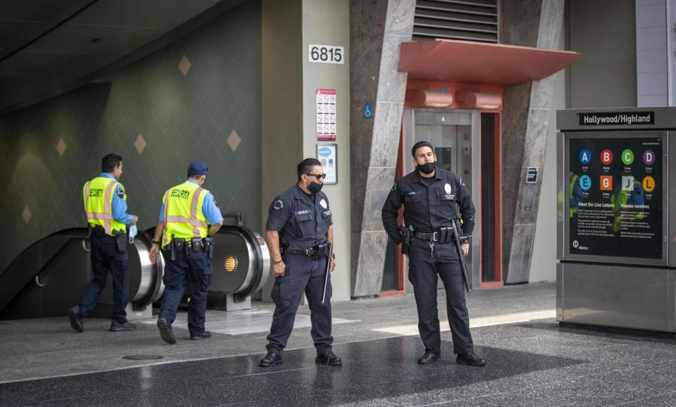 Men in uniforms in front of an entrance that goes underground.