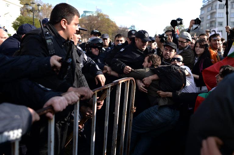 Policemen and protesters push each other in front of the Parliament building during an anti-government protest in Sofia on November 10, 2013