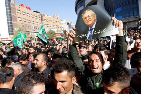 A Kurdish mourner holds a picture of former Iraqi president Jalal Talabani in Sulaimaniya, Iraq, October 6, 2017. REUTERS/Ako Rasheed
