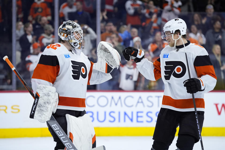 Philadelphia Flyers' Felix Sandstrom left, and Travis Sanheim celebrate after the Flyers won an NHL hockey game against the Ottawa Senators, Saturday, March 2, 2024, in Philadelphia. (AP Photo/Matt Slocum)