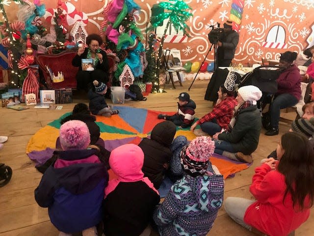 Stephanie Paredes reads to children at the Three Kings' Day celebration at Roc Holiday Village in 2019.