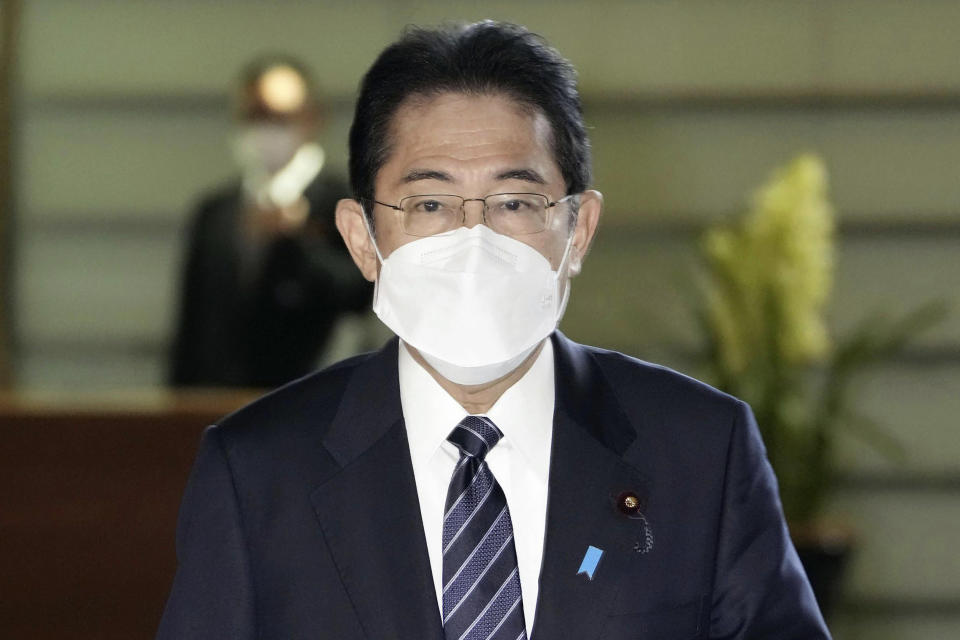 Japan's Prime Minister Fumio Kishida arrives at his office in Tokyo Friday, Jan. 20, 2023. Kishida on Friday announced plans to start preparations for downgrading legal status of COVID-19 to an equivalent of seasonal influenza in the spring, a move that would further relax mask wearing and other preventive measures as the country seeks an exit plan. (Kyodo News via AP)