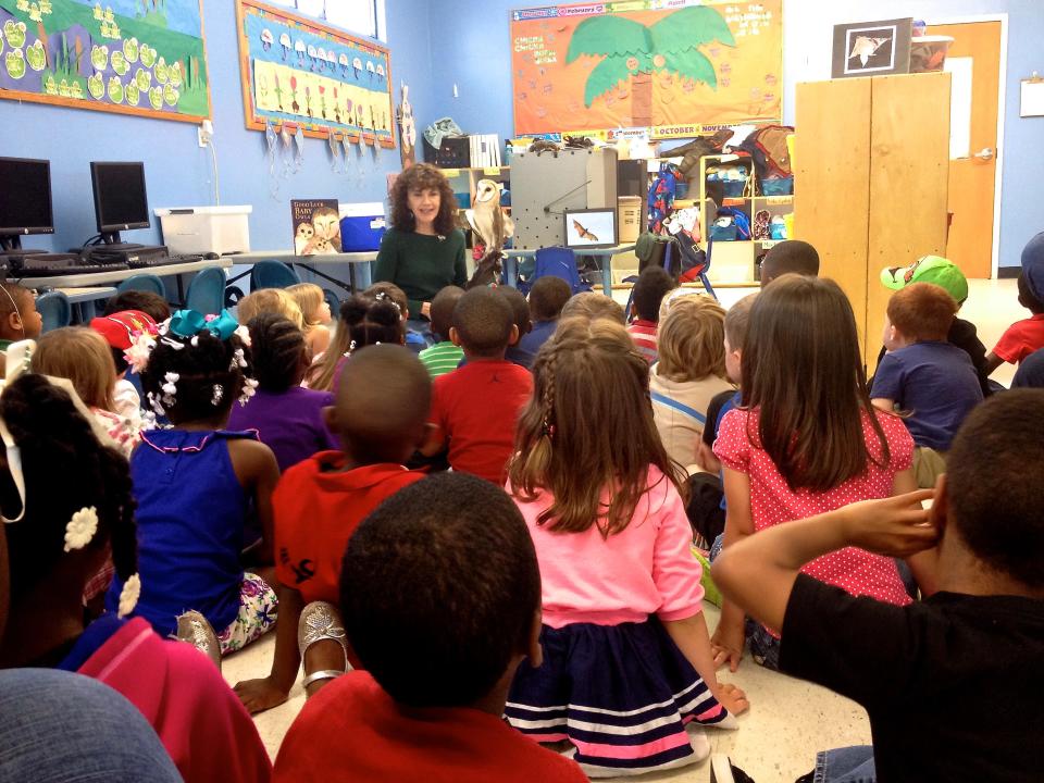 As St. Francis Wildlife’s educator, Sandy Beck has taught thousands of local children and adults about native wildlife. In this photo, first-graders at DeSoto Trail Elementary learn about Twiggy, a disabled Barn Owl.